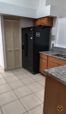 a kitchen with stainless steel appliances granite countertop a refrigerator and a stove