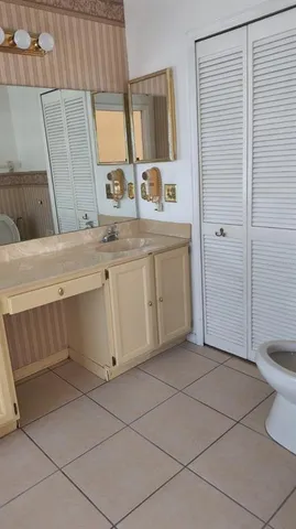 a bathroom with a sink a toilet and mirror