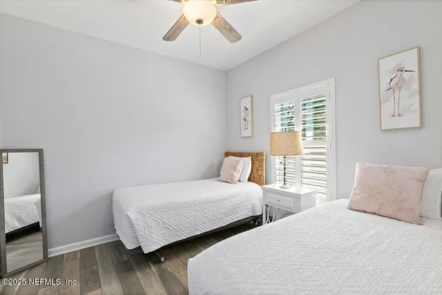 a bedroom with two beds and a chandelier