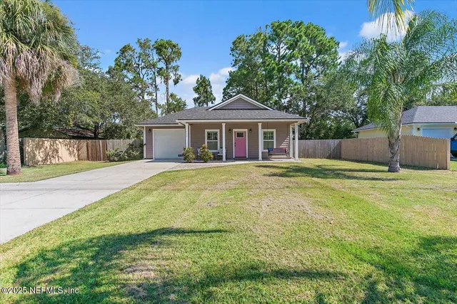 a view of a house with a backyard and a patio