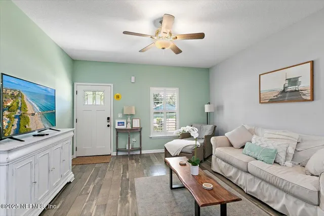 a living room with furniture and wooden floor