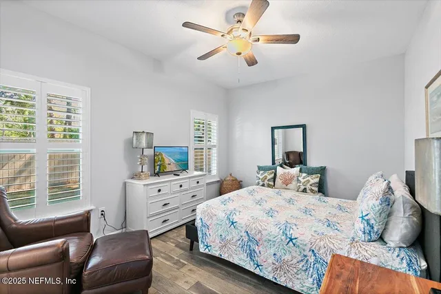 a bedroom with a bed a couch and a large window