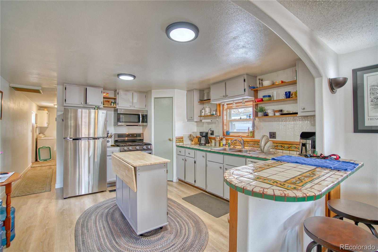 5000 Butte Street Boulder, CO 80301 - Photo 3 of 16 a kitchen with refrigerator and chairs