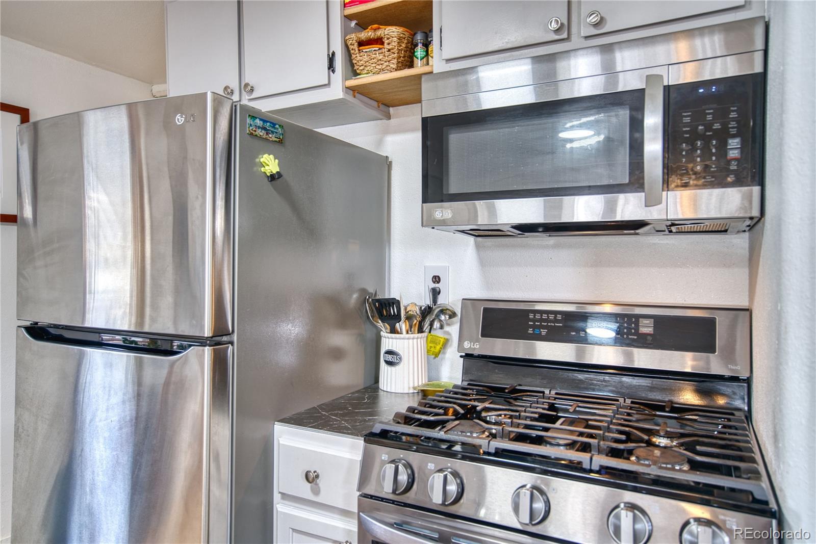 5000 Butte Street Boulder, CO 80301 - Photo 7 of 16 a kitchen with stainless steel appliances granite countertop a stove and a refrigerator