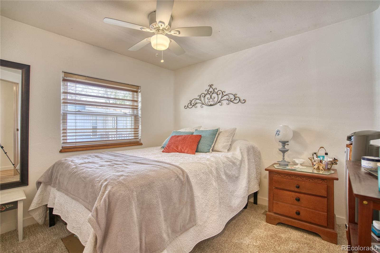 5000 Butte Street Boulder, CO 80301 - Photo 10 of 16 a bedroom with a bed and a chandelier