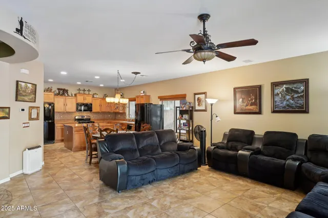 a room with lots of tables a chandelier and living room view