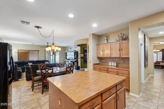 a living room with a dining table and paintings on the wall