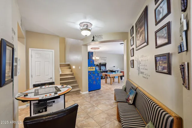a living room with furniture a rug and gym equipment