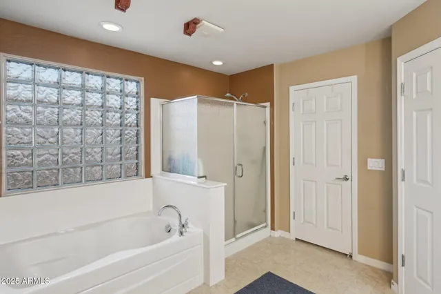 a bedroom with two beds and a large window