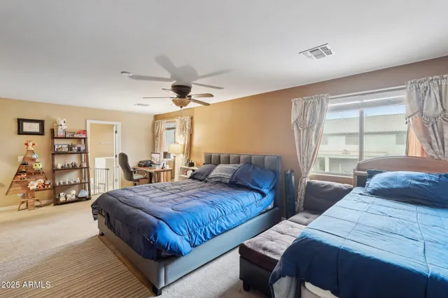 a bedroom with a bed a table and a book shelf