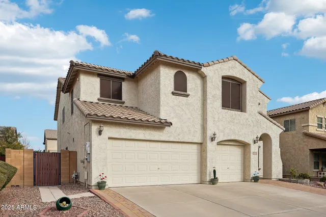 a view of a white house with large windows
