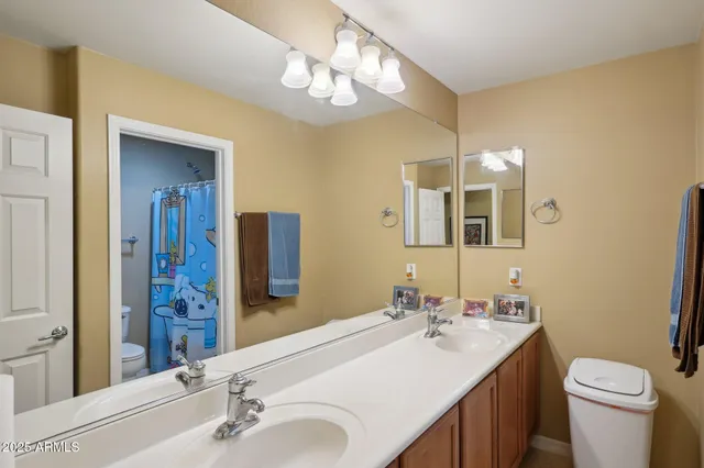 a room with lots of books and a painting on the wall