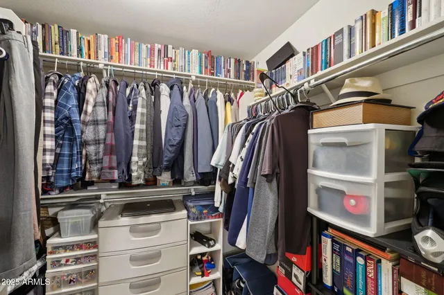 a bedroom with a bed and a dresser in it