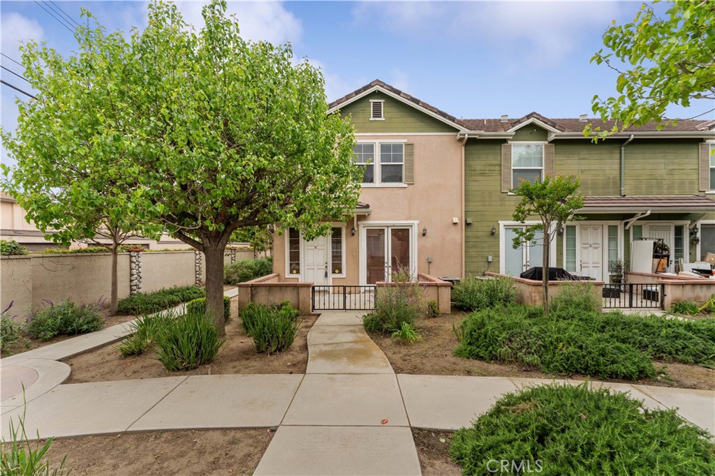 750 South Azusa Avenue, Unit H Azusa, CA 91702 - Photo 1 of 1 a front view of a house with a yard and potted plants