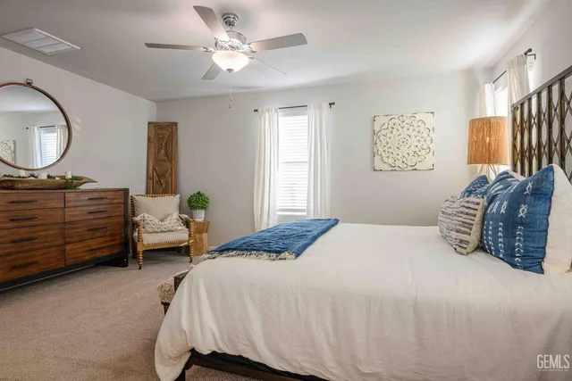 a bedroom with a bed dresser and a window