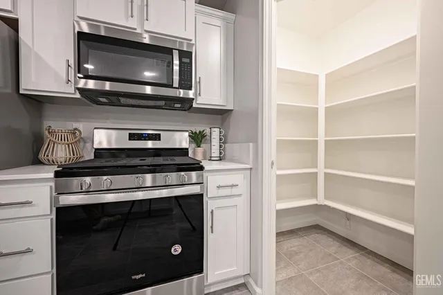 a kitchen with stainless steel appliances a stove microwave and cabinets