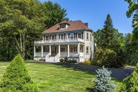 a front view of a house with a yard table and chairs