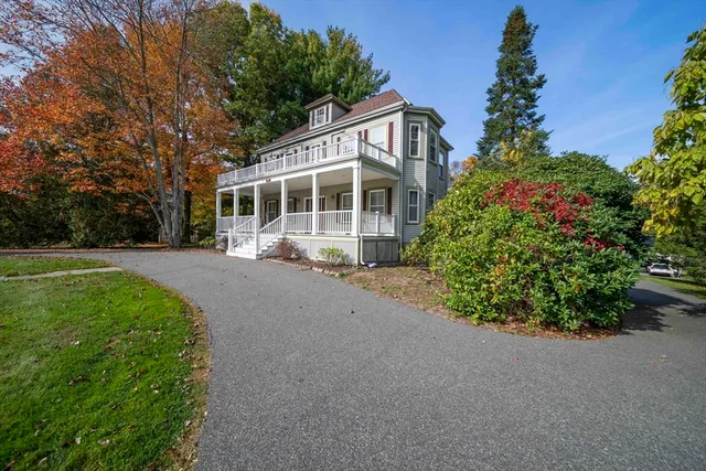 a front view of a house with a yard and a garage