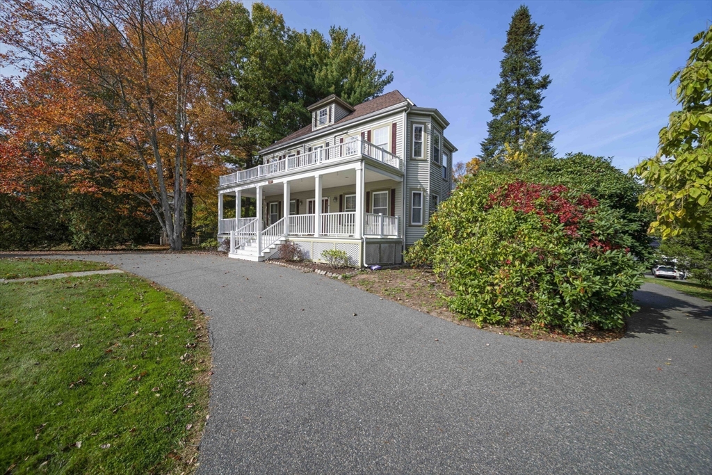 a view of a house with a garden and pathway