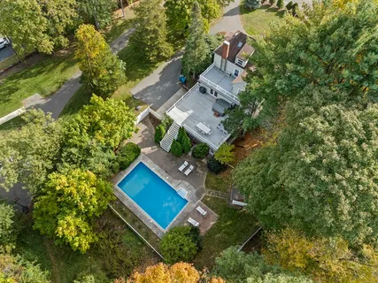 an aerial view of a house with yard