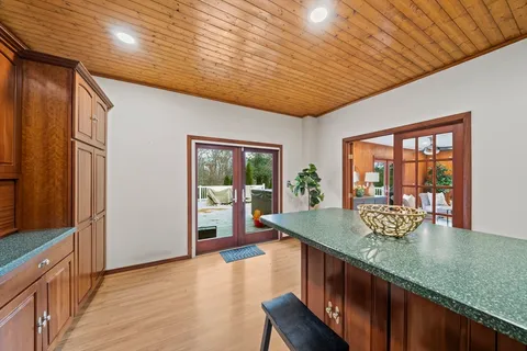 a kitchen with stainless steel appliances granite countertop a sink a stove and a wooden floors