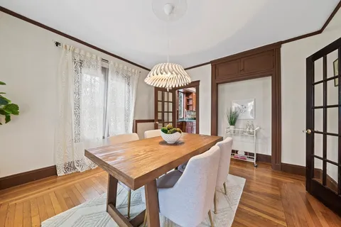 a view of a dining room with furniture window and wooden floor