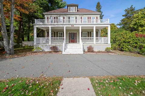 a front view of a house with a yard and a garage