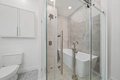 a bathroom with a shower and toilet
