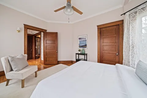 a bedroom with a bed and a chair