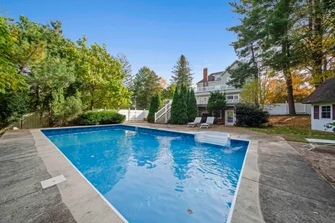 swimming pool view with a seating space