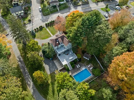 an aerial view of a house with a garden and swimming pool