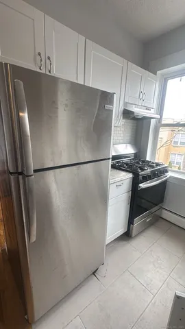 a kitchen with stainless steel appliances a refrigerator and a sink