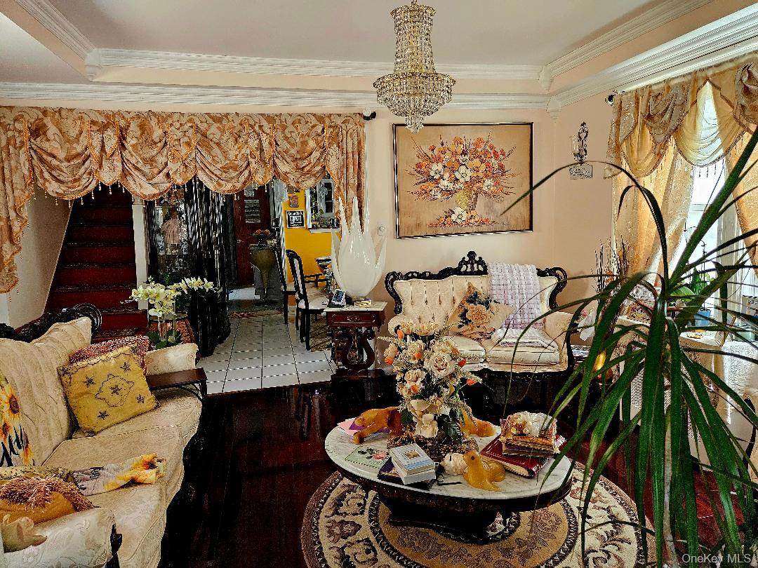 111-31 140th Street Queens, NY 11435 - Photo 15 of 20 a living room with furniture and a chandelier
