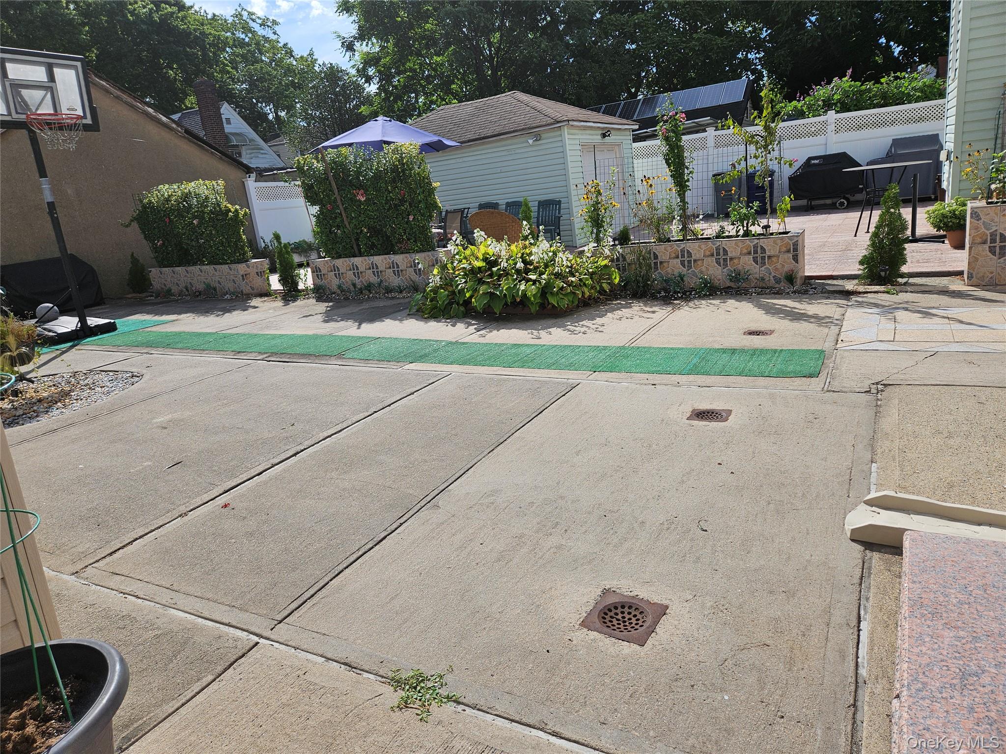 111-31 140th Street Queens, NY 11435 - Photo 18 of 20 a front view of a house with garden