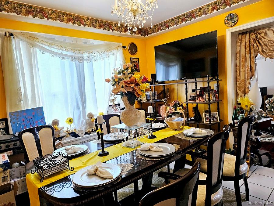111-31 140th Street Queens, NY 11435 - Photo 4 of 20 a dining room with furniture and a flat screen tv