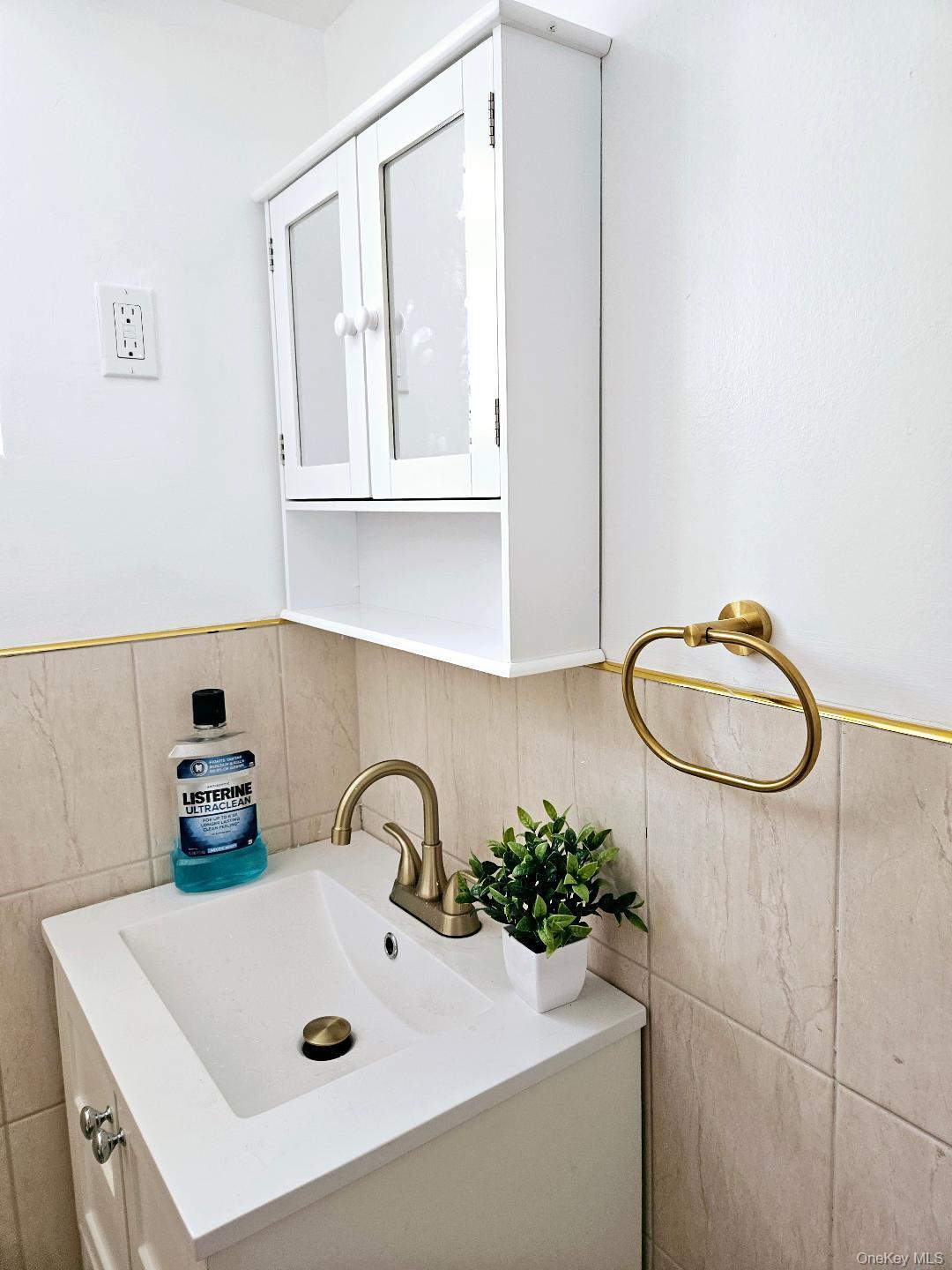 111-31 140th Street Queens, NY 11435 - Photo 7 of 20 a bathroom with a sink a mirror and vanity