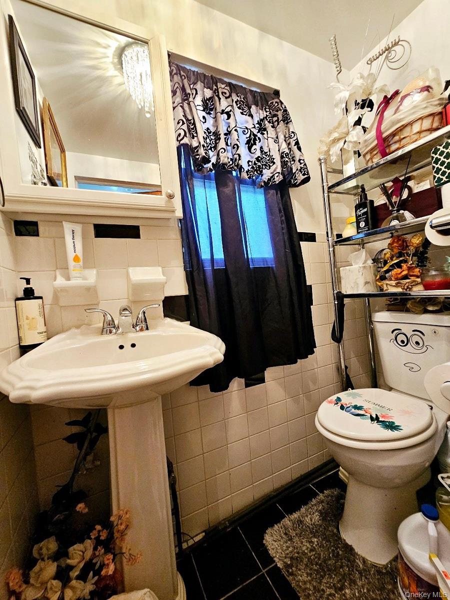 111-31 140th Street Queens, NY 11435 - Photo 8 of 20 a bathroom with a sink toilet and shower