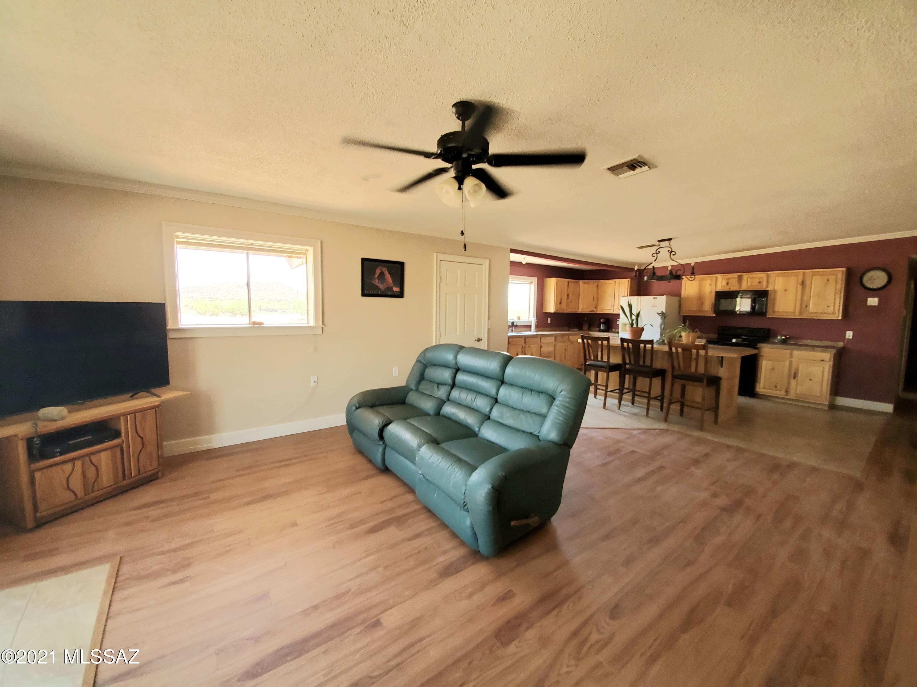 3440 East Howling Wolf Road Willcox, AZ 85643 - Photo 11 of 45 a living room with furniture and a flat screen tv