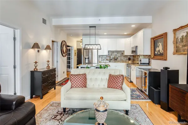 a kitchen with granite countertop stainless steel appliances a stove a sink a oven a dining table and chairs