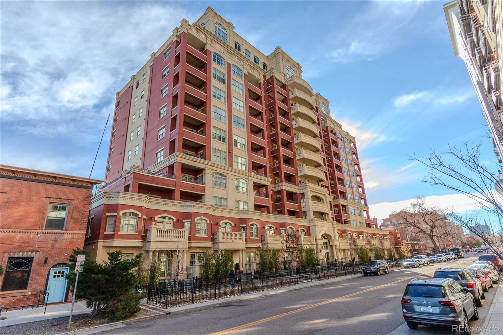 1950 Logan Street, Unit 814 Denver, CO 80203 - Photo 3 of 16 a view of a tall building next to a road