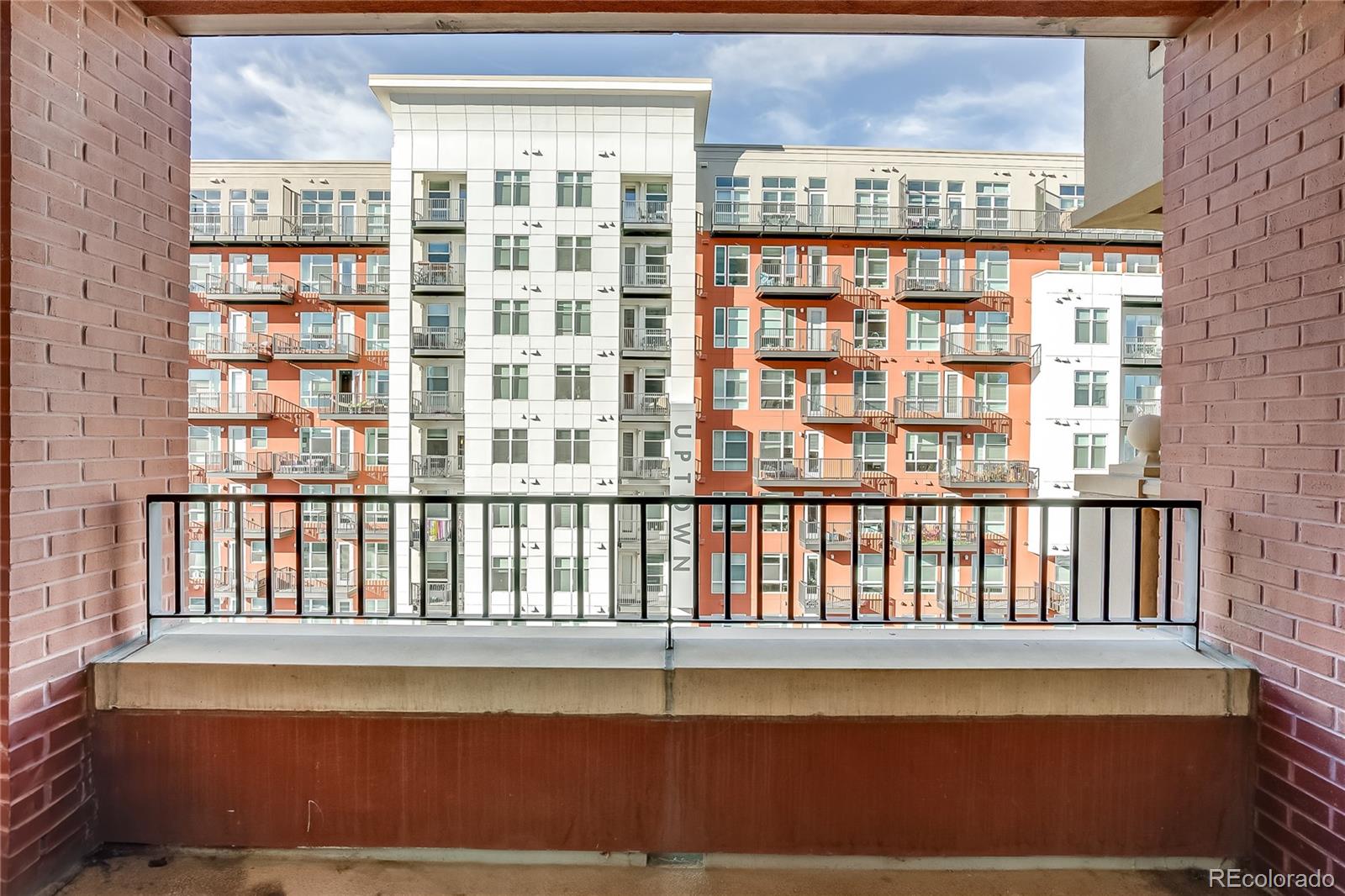 1950 Logan Street, Unit 814 Denver, CO 80203 - Photo 10 of 16 a view of a large building from a balcony