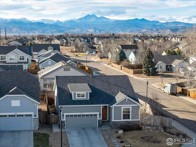 an aerial view of residential houses with a city view