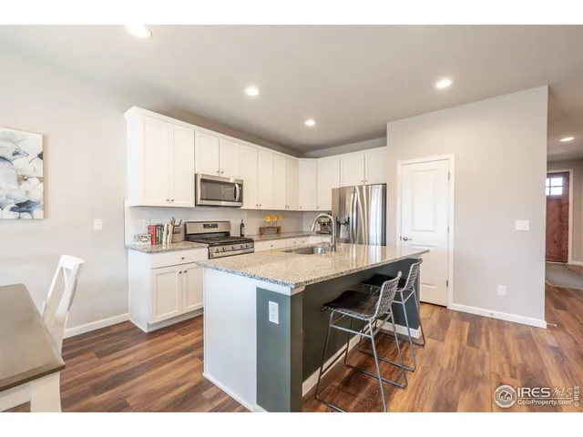 a kitchen with a sink a microwave and cabinets