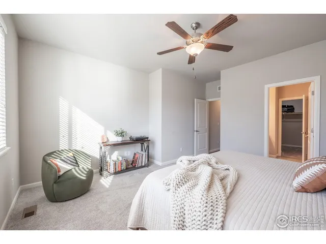 a bedroom with furniture and a large window