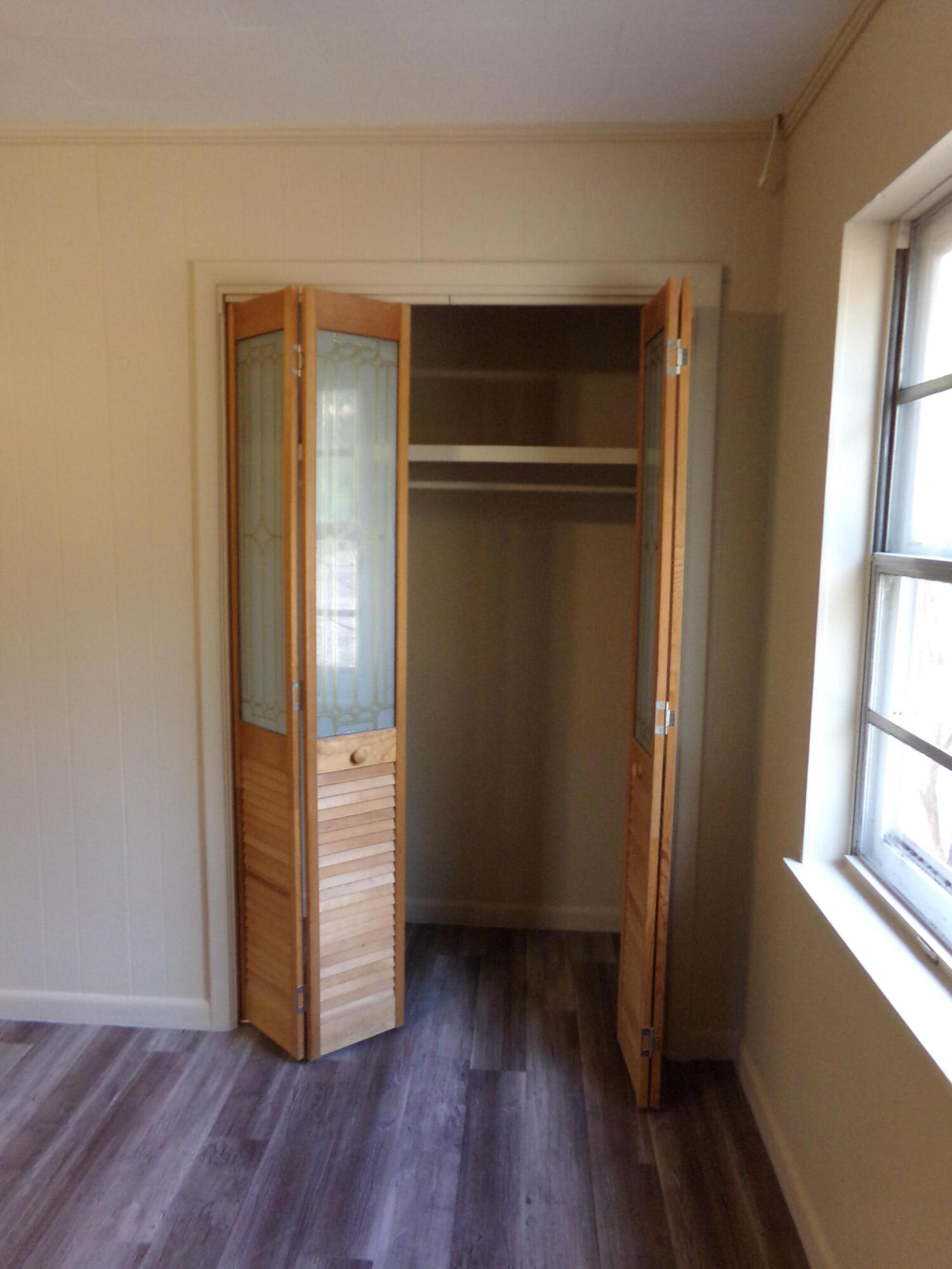 4071 Painter Branch Road Crestview, FL 32539 - Photo 20 of 64 an empty room with wooden floor and windows