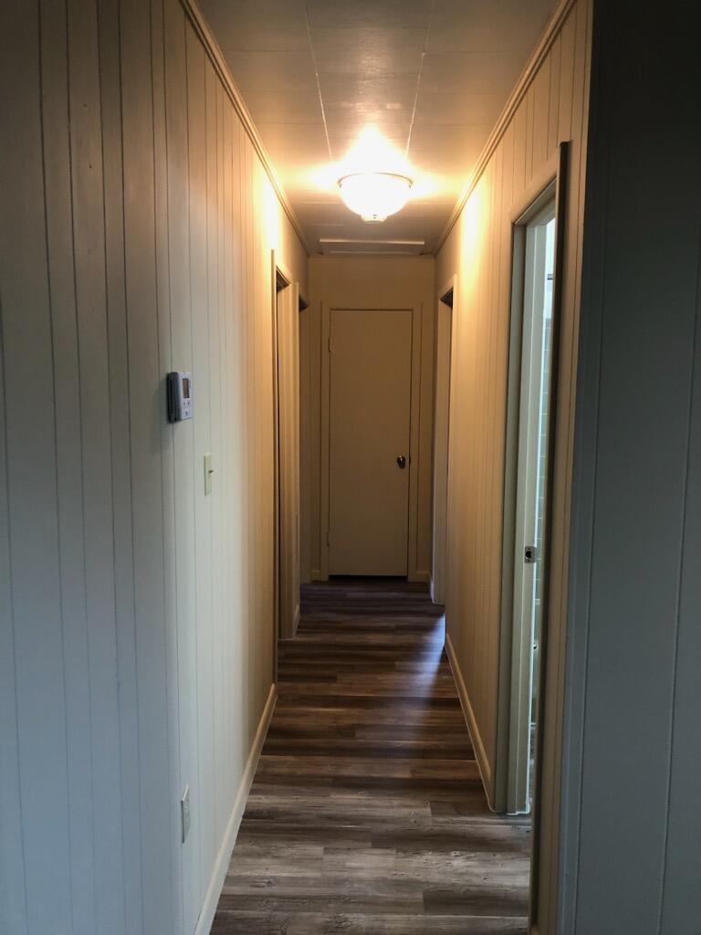 4071 Painter Branch Road Crestview, FL 32539 - Photo 44 of 64 a view of a hallway with wooden floor and staircase