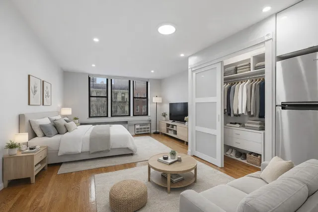 a bedroom with furniture and a flat screen tv