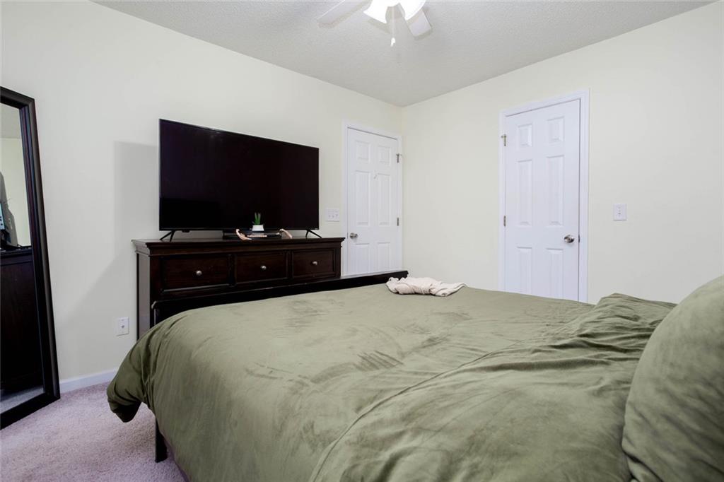 31 Abbey Lane Cartersville, GA 30120 - Photo 18 of 34 a bedroom with a bed and a flat screen tv