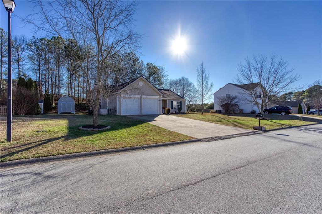 31 Abbey Lane Cartersville, GA 30120 - Photo 2 of 34 a view of the house with entertaining space and a small yard