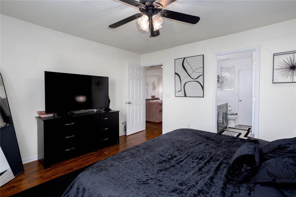 31 Abbey Lane Cartersville, GA 30120 - Photo 22 of 34 a bedroom with a bed and a flat tv screen on dresser